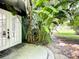 Inviting front entrance with double glass doors and lush tropical landscaping at 3417 Pershing Ave, Orlando, FL 32812