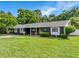 Charming home exterior with well-maintained lawn, dark paint, and inviting front porch at 3417 Pershing Ave, Orlando, FL 32812