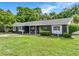 Attractive home with a lush front lawn, dark exterior, and a welcoming entryway at 3417 Pershing Ave, Orlando, FL 32812