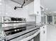 Close up of brand new stainless steel range with modern backsplash and granite counters at 3417 Pershing Ave, Orlando, FL 32812