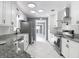 Bright kitchen with stainless steel appliances, white cabinetry, granite counters, and recessed lighting at 3417 Pershing Ave, Orlando, FL 32812
