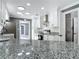Modern kitchen featuring white cabinets, stainless steel appliances, granite countertops, and tile backsplash at 3417 Pershing Ave, Orlando, FL 32812