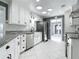 Newly remodeled kitchen with stainless steel appliances and granite countertops, all in white at 3417 Pershing Ave, Orlando, FL 32812