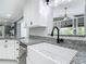 Farmhouse sink with granite countertops and modern fixtures in a remodeled kitchen at 3417 Pershing Ave, Orlando, FL 32812
