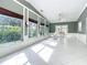 Bright, airy living room featuring decorative windows, elegant trim, and a glimpse of the lush outdoor space at 3417 Pershing Ave, Orlando, FL 32812