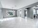 Bright living room features neutral walls, white tile flooring, backyard view, and French doors at 3417 Pershing Ave, Orlando, FL 32812
