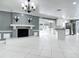 Living area with open floor plan showcases the fireplace and adjacent kitchen at 3417 Pershing Ave, Orlando, FL 32812