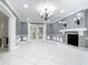 Living room with fireplace, sconces and french doors leading to the outdoors at 3417 Pershing Ave, Orlando, FL 32812