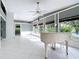Spacious living room featuring white tile floors, a grand piano, and elegant architectural details at 3417 Pershing Ave, Orlando, FL 32812