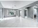 Open living room boasts tile floors, grey walls, and a view into a bathroom at 3417 Pershing Ave, Orlando, FL 32812
