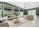 Open concept living and dining area with large windows providing ample natural light and serene green views at 3417 Pershing Ave, Orlando, FL 32812