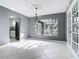 Bright living room features neutral walls, white tiled floors, view to kitchen and the backyard pergola at 3417 Pershing Ave, Orlando, FL 32812