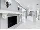 Open floor plan with fireplace and tile floors adjacent to a remodeled kitchen at 3417 Pershing Ave, Orlando, FL 32812