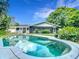 Backyard view of pool with pergola and blue skies reflecting off water's surface at 3417 Pershing Ave, Orlando, FL 32812