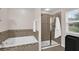 Well lit bathroom showcasing soaking tub, tiled detail, and glass enclosed shower at 3472 Gretchen Dr, Ocoee, FL 34761
