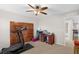 Bedroom featuring a ceiling fan, wood accent wall, and desk workspace at 3472 Gretchen Dr, Ocoee, FL 34761