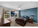 Bright bedroom with large windows, a ceiling fan, and an accent wall at 3472 Gretchen Dr, Ocoee, FL 34761