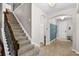 Home entryway featuring staircase, tile flooring, coat rack, and white trim at 3472 Gretchen Dr, Ocoee, FL 34761