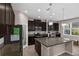 Modern kitchen with stainless steel appliances, dark cabinetry, large island, and window view at 3472 Gretchen Dr, Ocoee, FL 34761
