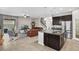 Open-concept space with kitchen island, living room, ceiling fan, and modern furnishings at 3472 Gretchen Dr, Ocoee, FL 34761