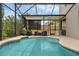 Screened-in pool featuring outdoor seating and sunshade with lush landscaping at 3472 Gretchen Dr, Ocoee, FL 34761