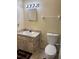 Bathroom featuring a single sink vanity, matching mirror, and standard toilet at 3700 Washington St, Sanford, FL 32771