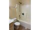 Bathroom features a combination tub and shower with tile surround and standard toilet at 3700 Washington St, Sanford, FL 32771
