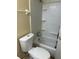Cozy bathroom view featuring white tiled shower and tub with toilet and storage at 3700 Washington St, Sanford, FL 32771