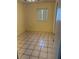A standard sized bedroom with tiled floors and a window letting in natural light at 3700 Washington St, Sanford, FL 32771