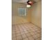A standard sized bedroom with tiled floors and a window letting in natural light at 3700 Washington St, Sanford, FL 32771