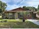 Charming single-story home featuring stone accents, a palm tree, and a well-maintained front yard at 3700 Washington St, Sanford, FL 32771