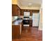 Traditional kitchen features dark wood cabinets, a white microwave, and a range at 3700 Washington St, Sanford, FL 32771