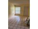 A well-lit living room with tile flooring, a front door, and a window providing natural light at 3700 Washington St, Sanford, FL 32771
