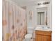 Cozy bathroom equipped with a shower, toilet, sink and vanity, and fresh white paint at 501 Lake Cummings Way, Lake Alfred, FL 33850