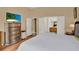 Spacious bedroom features a dresser and view of the bathroom, with hardwood floors at 501 Lake Cummings Way, Lake Alfred, FL 33850