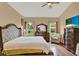Bright bedroom with ample natural light, hardwood floors, and comfortable furnishings at 501 Lake Cummings Way, Lake Alfred, FL 33850