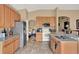 Bright open-concept kitchen featuring stainless steel appliances, granite countertops, and neutral-toned cabinetry at 501 Lake Cummings Way, Lake Alfred, FL 33850