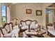 Comfortable living room showcasing plush seating, decorative lighting, and a view to other rooms at 501 Lake Cummings Way, Lake Alfred, FL 33850