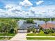 Beautiful single-story home featuring a lake view, lush landscaping, and a spacious three-car garage at 533 Quail Down Dr, Debary, FL 32713