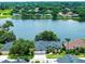 A lakefront home with meticulously maintained landscaping and view of the water at 533 Quail Down Dr, Debary, FL 32713