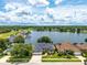 Gorgeous lakefront home with lush landscaping, mature trees, and a beautiful water view at 533 Quail Down Dr, Debary, FL 32713