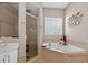 This bathroom features a walk-in shower and soaking tub with tile surround at 533 Quail Down Dr, Debary, FL 32713