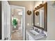 Well-lit bathroom featuring modern sink, faucet, mirror, and hallway access at 533 Quail Down Dr, Debary, FL 32713