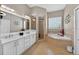 This bathroom features a double vanity, walk-in shower, and soaking tub with tile surround at 533 Quail Down Dr, Debary, FL 32713