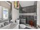 Modern bathroom with gray tiled shower featuring glass enclosure and a vanity with marble countertop at 533 Quail Down Dr, Debary, FL 32713
