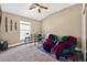This bedroom boasts carpeted floors, a ceiling fan, and a window with a view at 533 Quail Down Dr, Debary, FL 32713