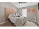 This bedroom features carpeted floors, a window, and a padded headboard at 533 Quail Down Dr, Debary, FL 32713