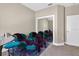 This bedroom features carpeted floors, seating, and a closet with mirror doors at 533 Quail Down Dr, Debary, FL 32713