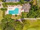 Aerial shot of the community pool, surrounded by lush greenery and a golf course fairway at 533 Quail Down Dr, Debary, FL 32713