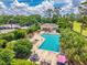 An aerial view of the community pool provides a relaxing oasis with comfortable lounge chairs and lush landscaping at 533 Quail Down Dr, Debary, FL 32713